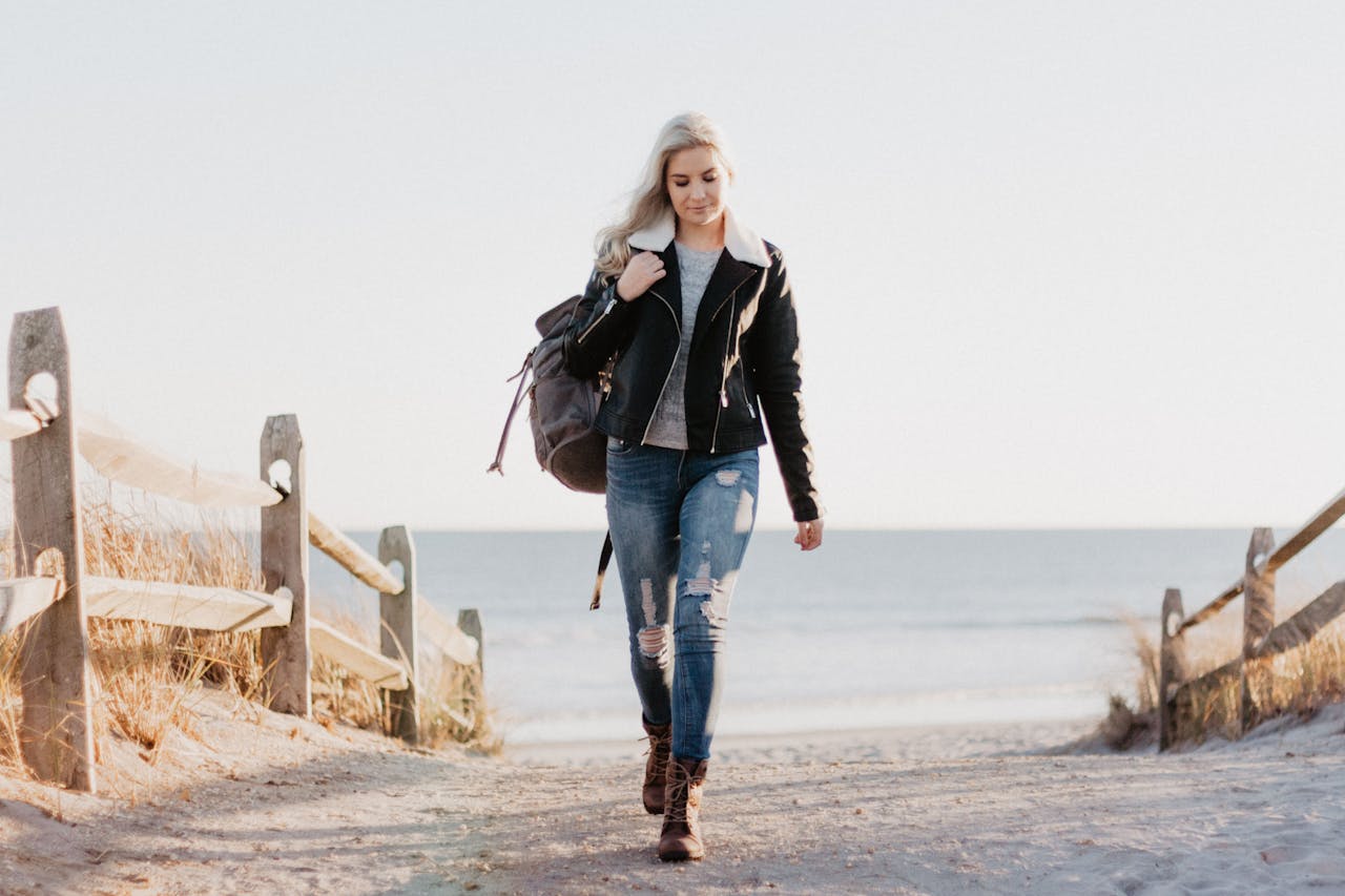 Services-02 Stylish woman in leather jacket walking by the ocean in Ocean City, NJ.